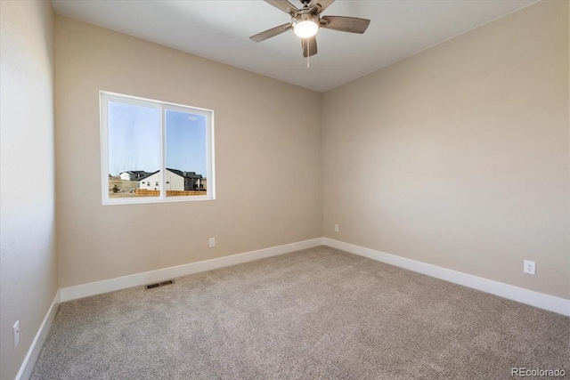 unfurnished room with light colored carpet and ceiling fan