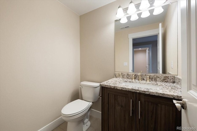 bathroom with tile patterned flooring, vanity, and toilet