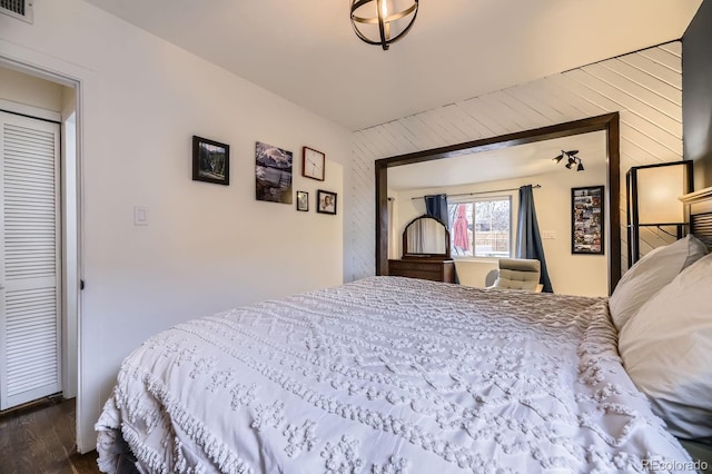 bedroom with dark hardwood / wood-style floors