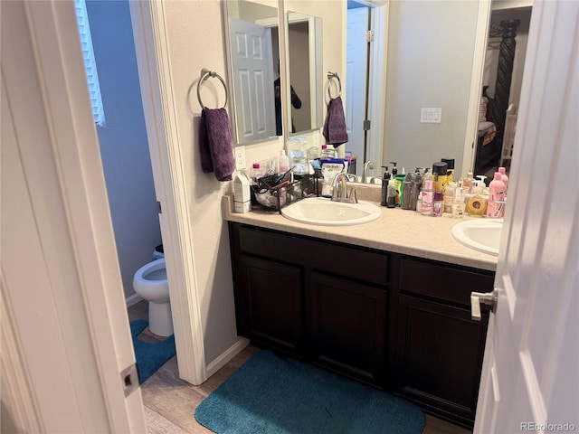 bathroom featuring vanity, toilet, and hardwood / wood-style floors