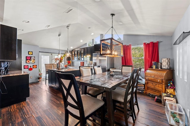 dining area featuring lofted ceiling and dark hardwood / wood-style floors