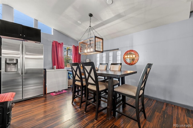 dining room with lofted ceiling and dark hardwood / wood-style floors