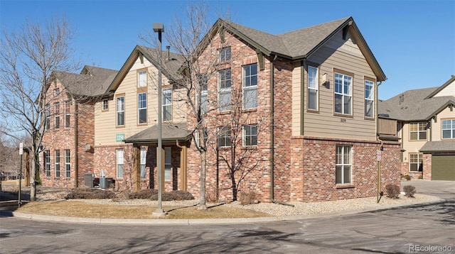 2250 S Vaughn Way Unit 204, Aurora, CO 80014 - view of front of house featuring brick siding and driveway