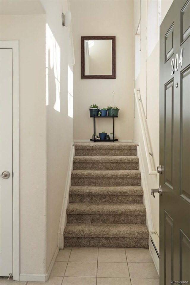 2250 S Vaughn Way Unit 204, Aurora, CO 80014 - stairs featuring baseboards and tile patterned flooring