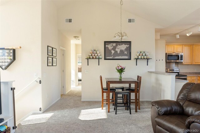 2250 S Vaughn Way Unit 204, Aurora, CO 80014 - dining area with light colored carpet, high vaulted ceiling, and track lighting