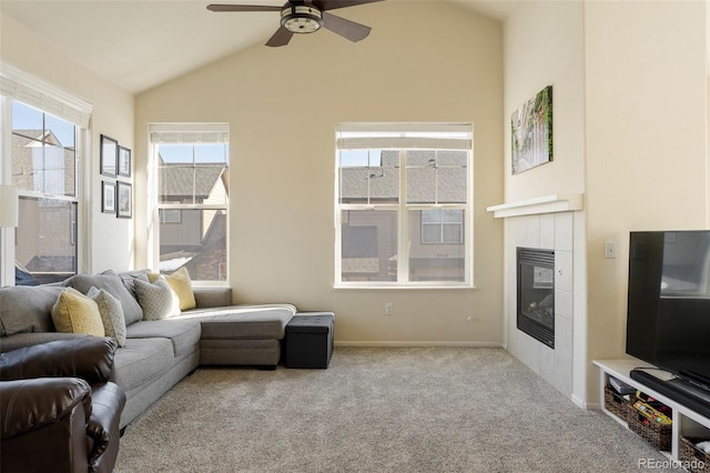 2250 S Vaughn Way Unit 204, Aurora, CO 80014 - carpeted living area with a tiled fireplace, a ceiling fan, and lofted ceiling