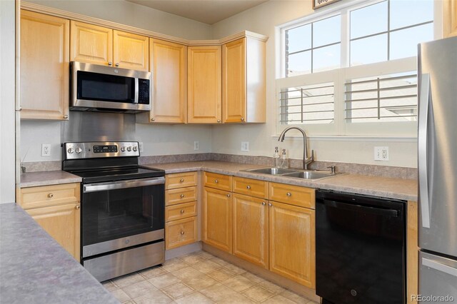 2250 S Vaughn Way Unit 204, Aurora, CO 80014 - kitchen featuring appliances with stainless steel finishes, light brown cabinetry, and light countertops