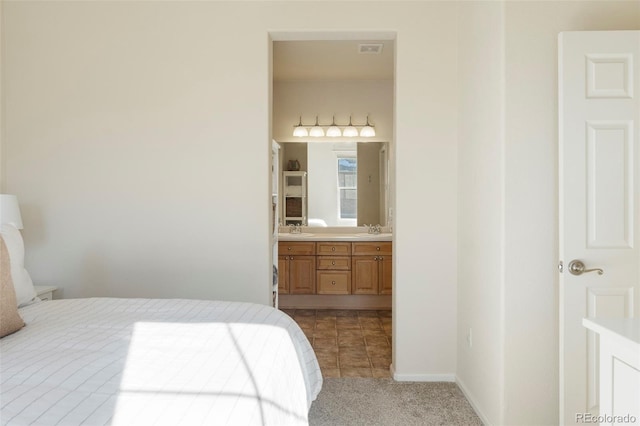 2250 S Vaughn Way Unit 204, Aurora, CO 80014 - bedroom with light carpet and ensuite bathroom