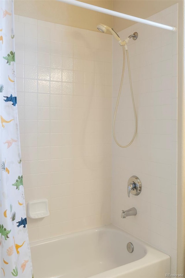 2250 S Vaughn Way Unit 204, Aurora, CO 80014 - bathroom featuring shower / tub combo with curtain