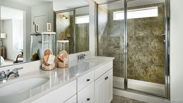 39733 Penn Rd, Elizabeth, CO 80107 - bathroom featuring healthy amount of natural light, a shower stall, double vanity, and tile patterned floors