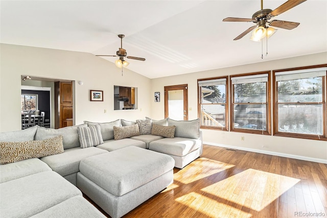 living room with ceiling fan, hardwood / wood-style floors, and lofted ceiling