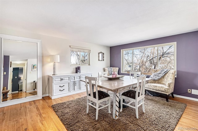 dining area with plenty of natural light and light wood-type flooring