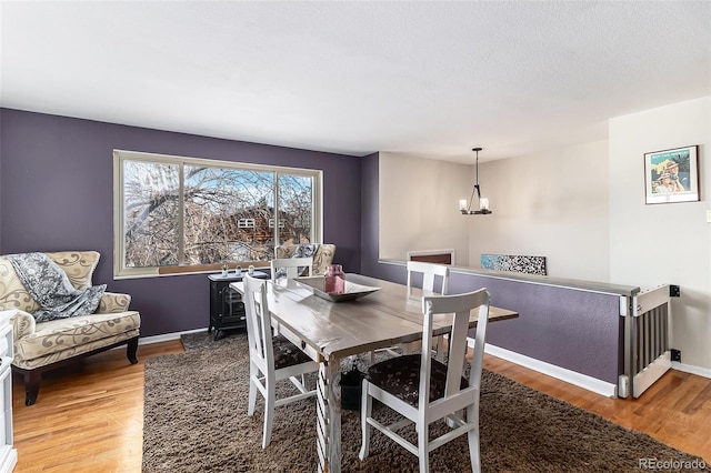 dining area featuring hardwood / wood-style floors and a notable chandelier