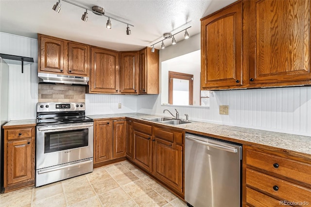 kitchen featuring sink, a textured ceiling, and appliances with stainless steel finishes