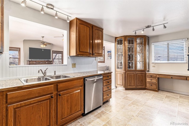 kitchen with stainless steel dishwasher, ceiling fan, lofted ceiling, and sink