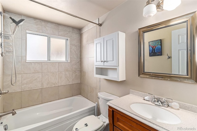 full bathroom with vanity, tiled shower / bath combo, and toilet