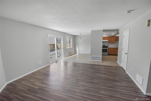 unfurnished living room with wood-type flooring