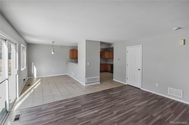 unfurnished living room with tile patterned flooring