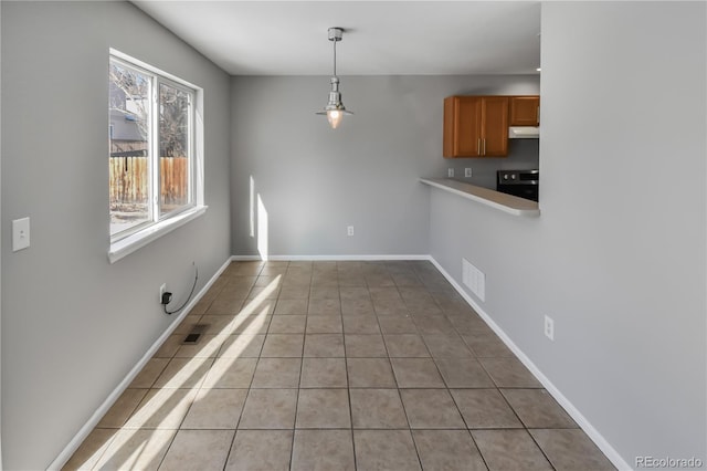 unfurnished dining area featuring light tile patterned flooring