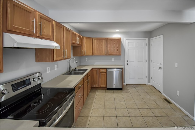 kitchen featuring appliances with stainless steel finishes, sink, and light tile patterned floors