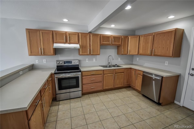 kitchen featuring stainless steel appliances, sink, and light tile patterned floors