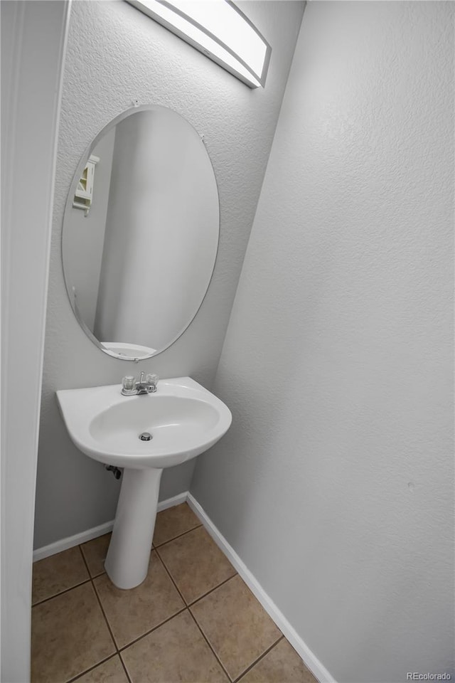 bathroom with tile patterned floors