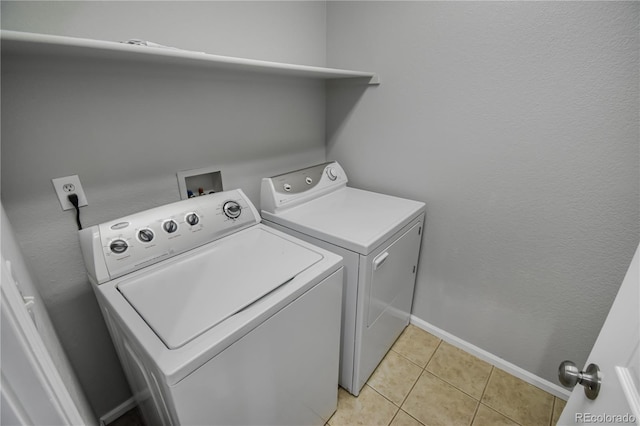 washroom with light tile patterned floors and independent washer and dryer