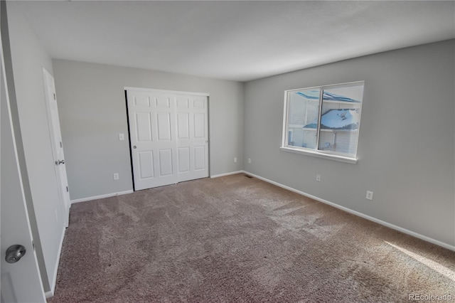 unfurnished bedroom with carpet flooring and a closet