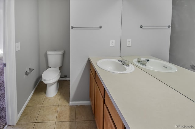 bathroom featuring vanity, tile patterned floors, and toilet