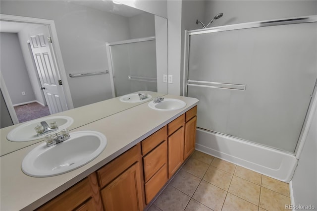 bathroom featuring tile patterned flooring, vanity, and shower / bath combination with glass door