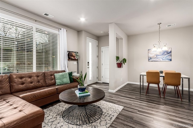 5187 S Fairplay St, Aurora, CO 80015 - living room featuring an inviting chandelier, baseboards, dark wood finished floors, and visible vents