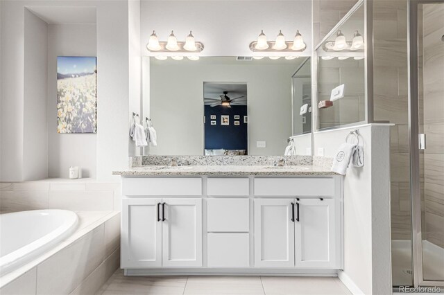 5187 S Fairplay St, Aurora, CO 80015 - bathroom with double vanity, ceiling fan, a bath, a shower stall, and ensuite bath