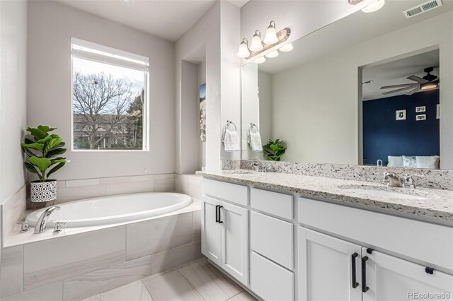 5187 S Fairplay St, Aurora, CO 80015 - full bath with visible vents, a sink, a garden tub, and double vanity