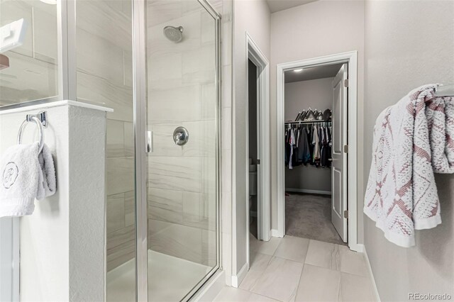 5187 S Fairplay St, Aurora, CO 80015 - full bathroom featuring baseboards, a stall shower, and a spacious closet