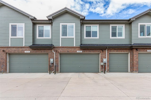 5187 S Fairplay St, Aurora, CO 80015 - view of property featuring brick siding, driveway, and a garage