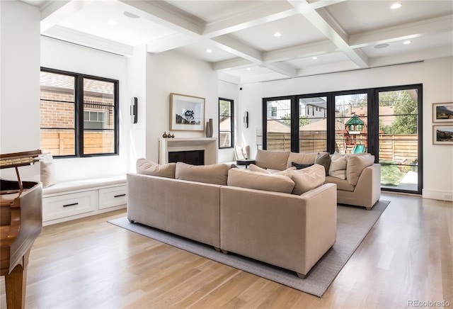 living room featuring coffered ceiling, beam ceiling, and light hardwood / wood-style flooring