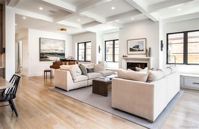 living room with beam ceiling, light hardwood / wood-style flooring, and coffered ceiling