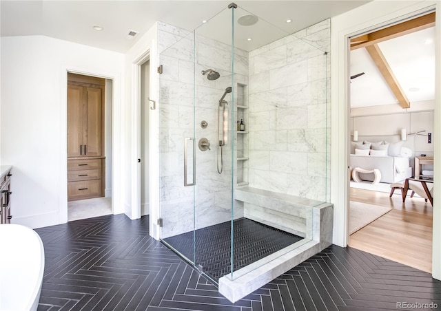 bathroom featuring hardwood / wood-style floors and walk in shower