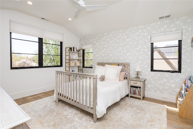 bedroom with hardwood / wood-style flooring, ceiling fan, and lofted ceiling