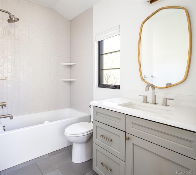 full bathroom featuring tile patterned floors, vanity, toilet, and tiled shower / bath