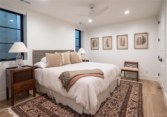 bedroom with ceiling fan and light hardwood / wood-style floors