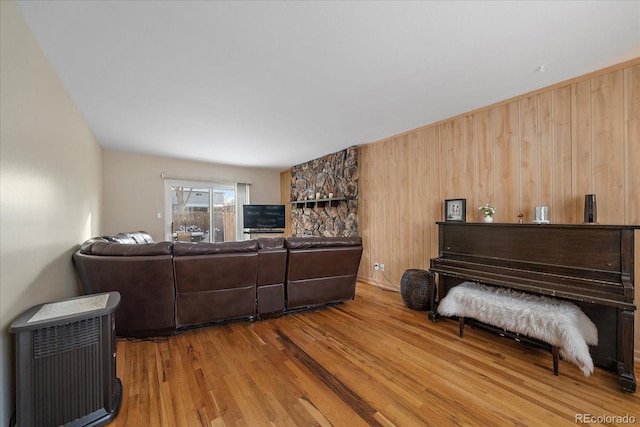 living room with wooden walls and hardwood / wood-style floors