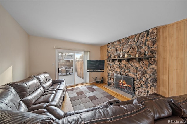 living room with light wood-type flooring and a fireplace