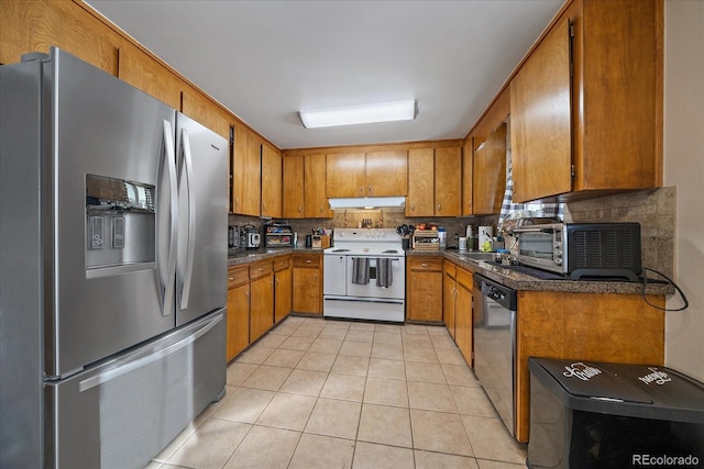 kitchen featuring backsplash, stainless steel appliances, sink, and light tile patterned floors