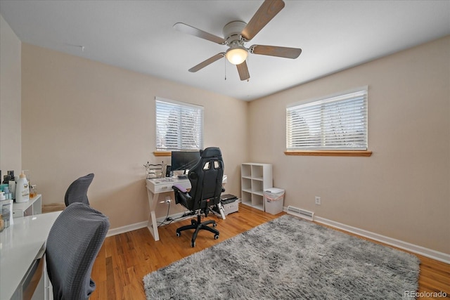 office space featuring ceiling fan and light wood-type flooring