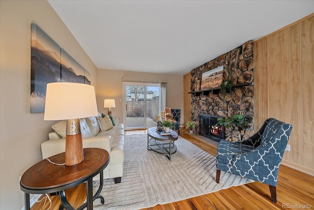 living room with wood finished floors and a fireplace