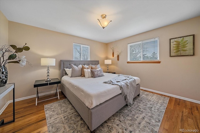 bedroom featuring baseboards and wood finished floors