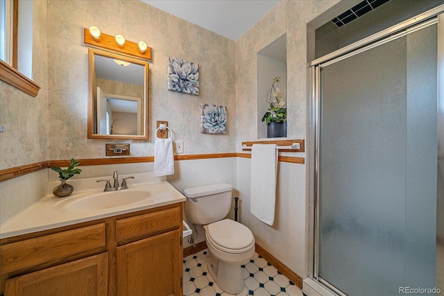 bathroom featuring toilet, a stall shower, wallpapered walls, and vanity