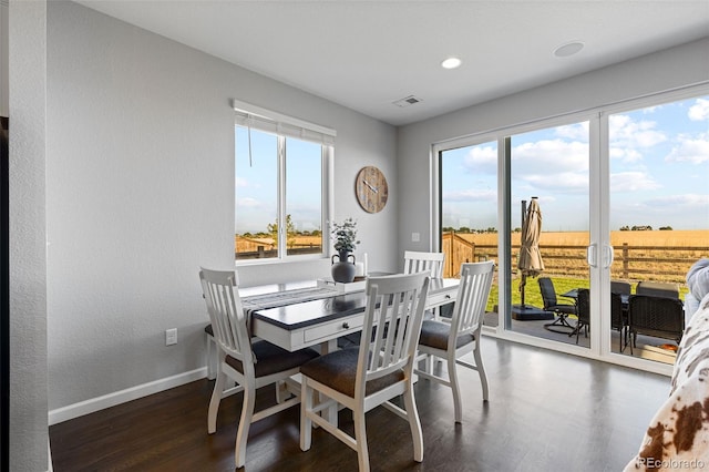 dining area with dark hardwood / wood-style flooring