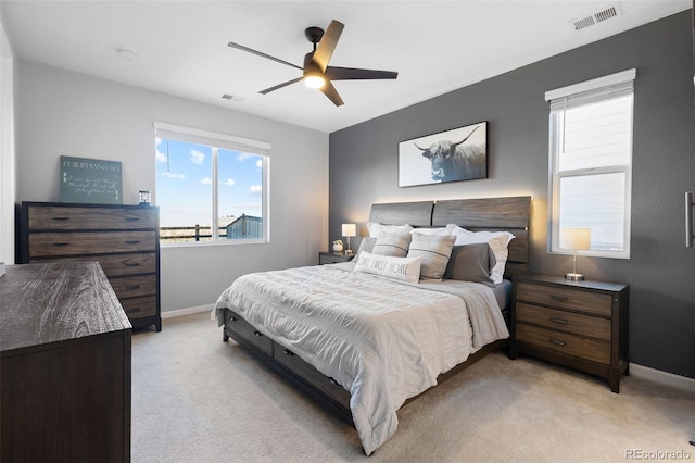 bedroom featuring ceiling fan and light colored carpet